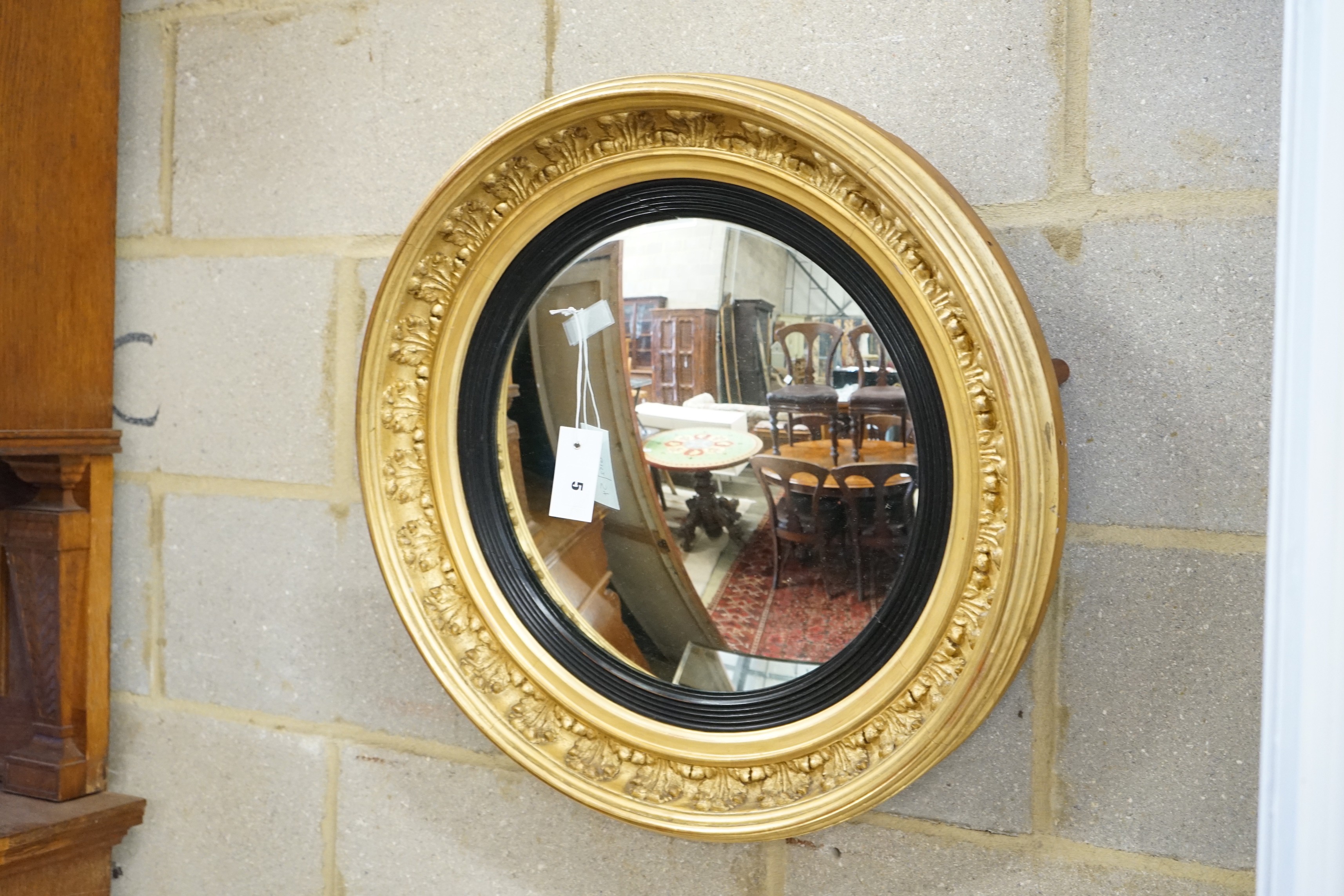 A Regency circular giltwood and gesso convex wall mirror, diameter 57cm